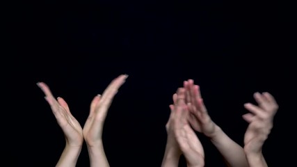 Hands isolated on black background giving applause. Hands clapping on black, front view