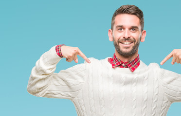 Young handsome man wearing winter sweater over isolated background looking confident with smile on...
