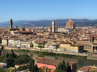 Fototapeta na wymiar Aerial view of the tower of Palazzo Vecchio or Palazzo della Signoria (The Old Palace), Florence Cathedral and Duomo tower from Michelangelo Square.