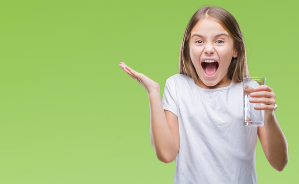 Young Beautiful Girl Drinking Glass Of Water Over Isolated Background Very Happy And Excited, Winner Expression Celebrating Victory Screaming With Big Smile And Raised Hands