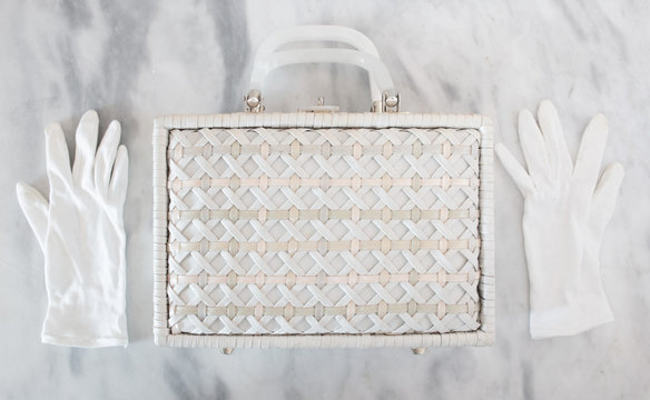 White Wicker Basket Purse with White Gloves on a marble table