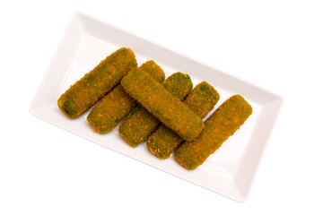 Spinach sticks on a tray on a white background seen from above