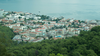 Fototapeta na wymiar Mountain town panoramic view. city between the hills with the sea