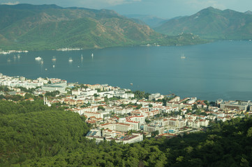 Mountain town panoramic view. city between the hills with the sea