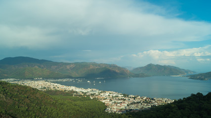 Mountain town panoramic view. city between the hills with the sea