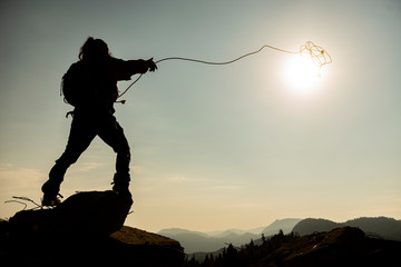 creative concept of catching the sun and throwing lasso