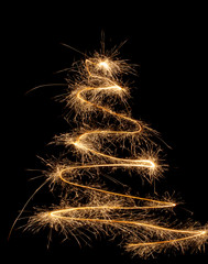 The minimalist Christmas tree. new year. it's written in fireworks.