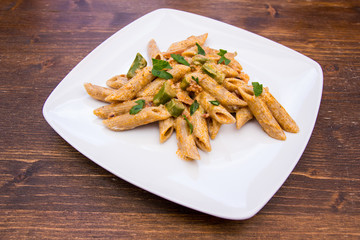 Pasta with asparagus and cream on a wooden table