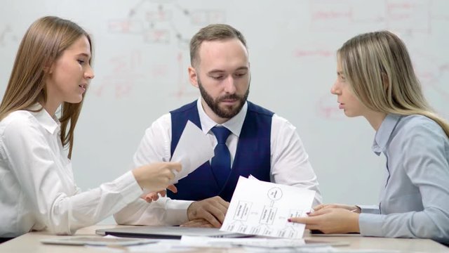 Two young disgruntled businesswoman partners arguing about mistake in document
