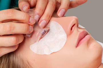 Eyelash care treatment procedures. Woman doing lashes lamination