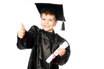 A Young boy 4 years old in graduation dress for the nursery class