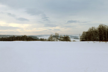 Winter landscape - frosty trees in snowy forest. Road in a wonderful winter forest
