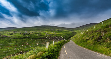 Fototapeta na wymiar The world famous Ring of Kerry is a 'must do' scenic tourist drive or cycle in County Kerry, in the south west of Ireland. Very foggy but still beutiful. Wild Atlantic Way