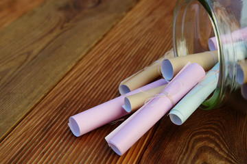 Dreams in a glass jar on wooden table. Wishes for life over wooden background with copy space.