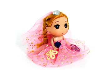 Cute doll in a pink dress with flowers