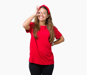 Obraz na płótnie Canvas Young beautiful brunette woman wearing red t-shirt over isolated background doing ok gesture with hand smiling, eye looking through fingers with happy face.
