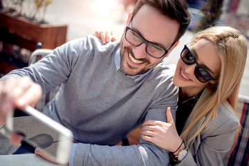 Young couple taking selfie in the city