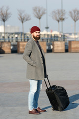 Man bearded hipster travel with big luggage bag on wheels. Let travel begin. Traveler with suitcase...