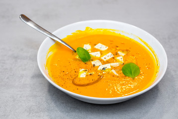Pumpkin soup on the grey concrete table