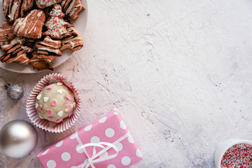 Top view of delicious sweets and Christmas decoration, against white textured background. 