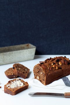 Sliced fruit bread, with a slice spread with butter
