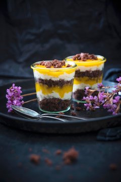 Vegan desserts made with chocolate cake, vanilla semolina cream, and mango pur&eacute;e