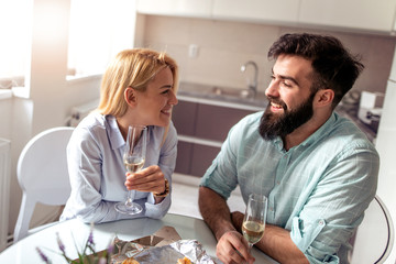 Young couple drink wine at home