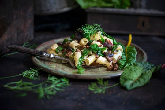 Pasta with swiss chard, mushrooms and tofu served on plate