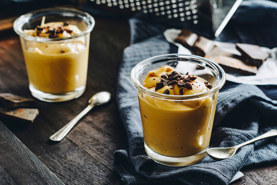 Caramel pudding garnished with chocolate in glass