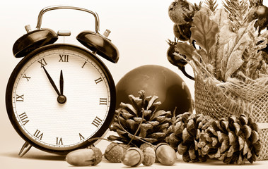 Composition of clock and christmas decorations on bright background