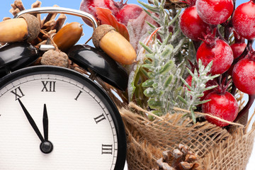 Composition of clock and christmas decorations on bright background