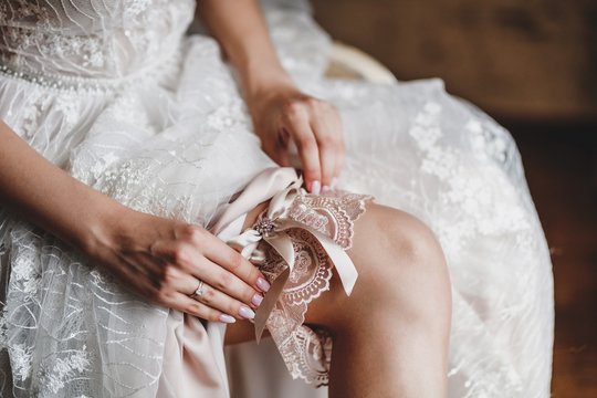 The bride wears a garter on her wedding day.
