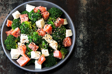 Poke bowl with salmon. Salmon broccoli sesame poke. Top view. Food sticks.
