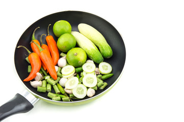 orange, mini sweet peppers and vegetable  in pan