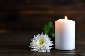 Condolence card with candle and white Chrysanthemum flower 