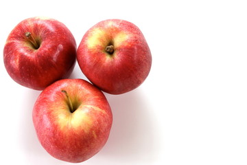 Three red apples on white background