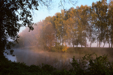 Naklejka na ściany i meble fog over the river at dawn