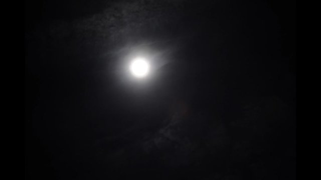 luna llena oculta por el paso de las nubes en invierno