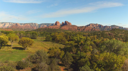 AERIAL: Black SUV car driving through beautiful Sedona state park, Arizona