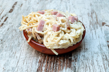 Spaghetti a la carbonara surrounded by rustic background