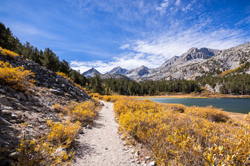 Little Lakes Valley hiking trail on a sunny fall day, following the shoreline of Long Lake in the Eastern Sierras; John Muir Wilderness; California
