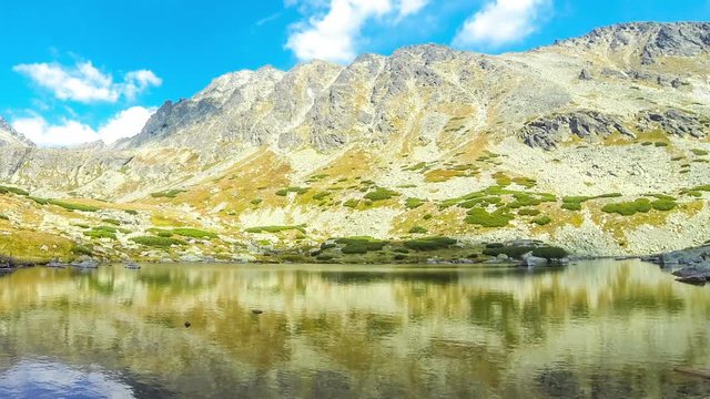 Hiking in High Tatras Mountains, Slovakia. Lake over Skok waterfall (Slovak: Pleso nad Skokom) (1801m). Mounts Satan (2421m), Predna Basta (2374m), Mala Basta (2288m) on the background. Time Lapse