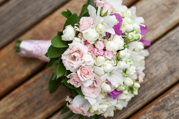 Bridal bouquet in rustic place, for use in wedding websites or blogs.