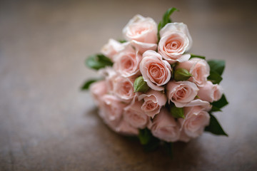 Bridal bouquet in rustic place, for use in wedding websites or blogs.