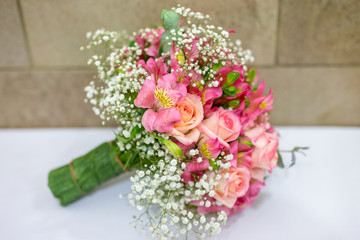 Bridal bouquet in rustic place, for use in wedding websites or blogs.