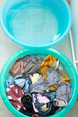 washing colorful clothes in the basin.