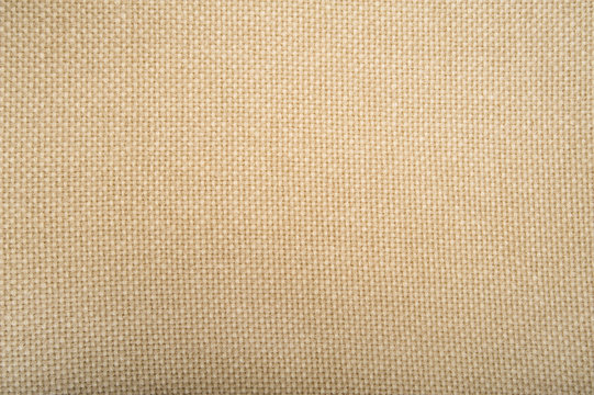 wool knitted beige fabric texture close-up background 
