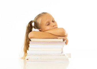 Exhausted schoolgirl falling asleep on her books after studying too much