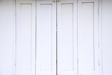 Old white wooden window on white wall.
