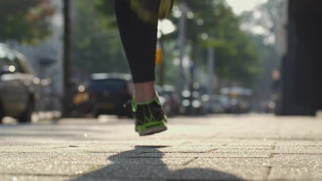 Woman running in a city. Slow motion shot.